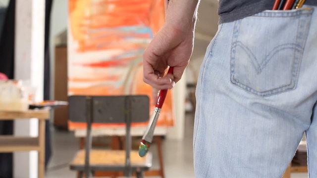 Painter looking at his easel 