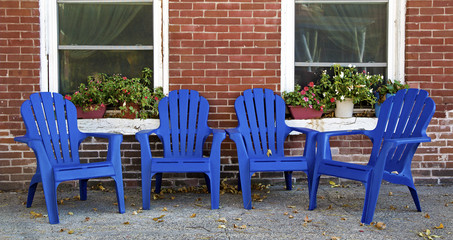 Adirondack chairs in front of a brick building