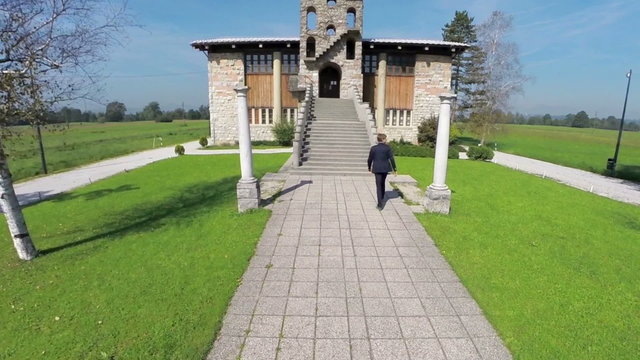 Man walking to the stairs in to a nice bulding