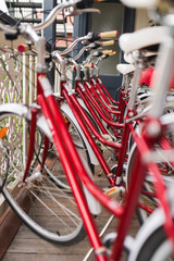 City bikes for rent. Row of city bicycles parked near hostel