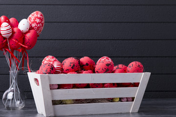 Red Easter eggs in a wooden container