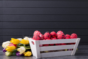 Red Easter eggs in a wooden container