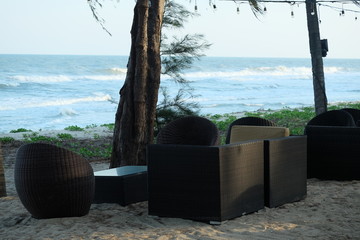 rattan chair on the beach beside the sea