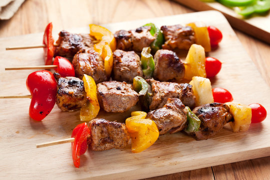 grilled pork barbecue and vegetable on wooden board