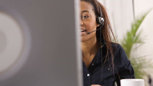 Woman in office talking with headset