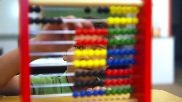School student using an abacus