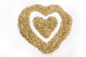 Green lentils in a heart shape, isolated on a white background