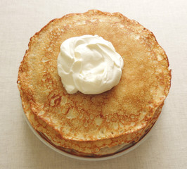  Pancakes with sour cream.  Shrove Tuesday pancakes on the table. 