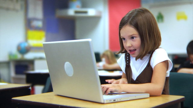 School student working on laptop computer