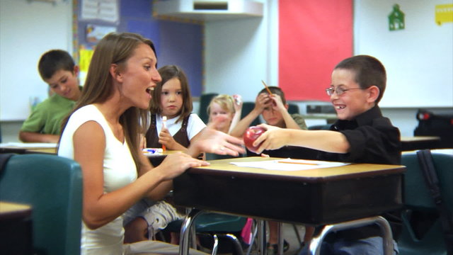 Student gives teacher an apple