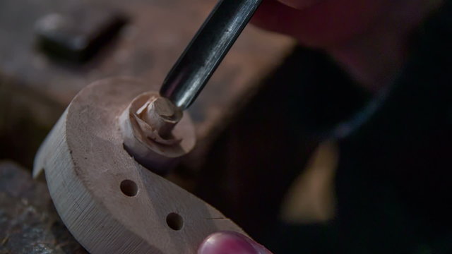 Carving a piece of violin 