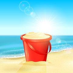 Bucket of sand on beach