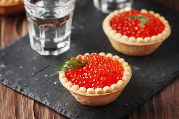 Traditional russian red caviare on the wooden table