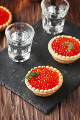 Traditional russian red caviare on the wooden table