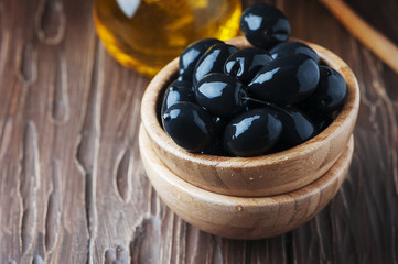 Greek black olive and oil on the wooden table