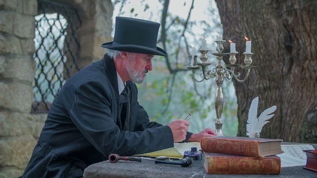 Composer picking up the glasses to read 