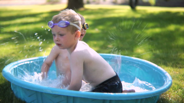 Boys playing in a kiddie pool