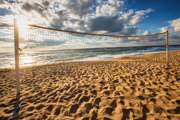 Volleyball net and sunrise on the beach