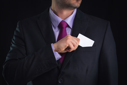 Business man showing a blank business card isolated, close up