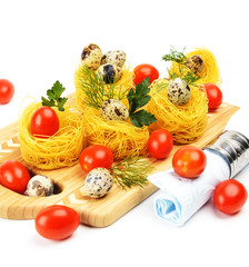 Pasta nests with cherry tomatoes and quail eggs.