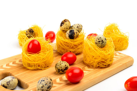 Pasta nests with cherry tomatoes and quail eggs.
