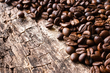 roasted coffee beans on a wooden background close up
