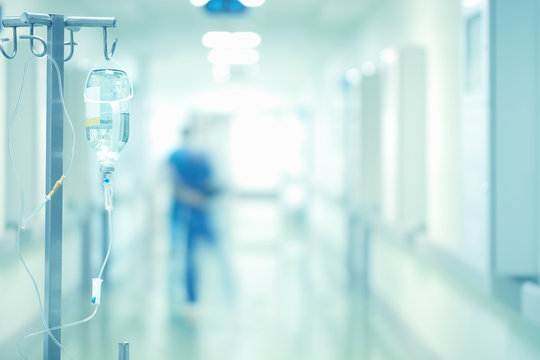 Medical Drip In The Blurred Background Of Doctors