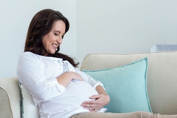 Pregnant woman resting on couch 