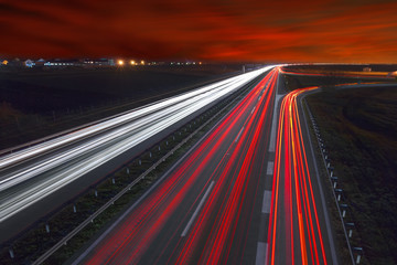 Light trails on highway at beautiful sunset