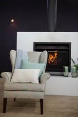 Armchair next to fireplace