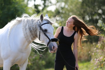 Ginger girl with white andalusian horse © anael_g