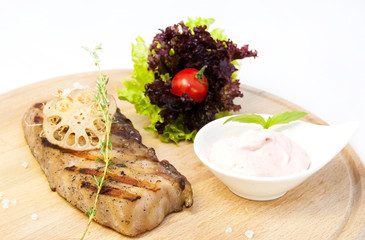 Catfish steak cooking on a grill in the restaurant