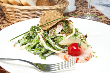 salad greens and shrimp meat on a white background