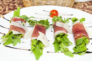 rolls of meat and greens on a white background in the restaurant