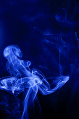 Blue smoke on a black background.
