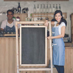 asian female cafe owner with blank board