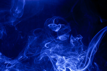 Blue smoke on a black background.