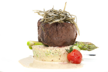 Grilled steak with sauce and greens on white background