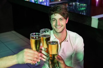 Happy man toasting his glass of beer