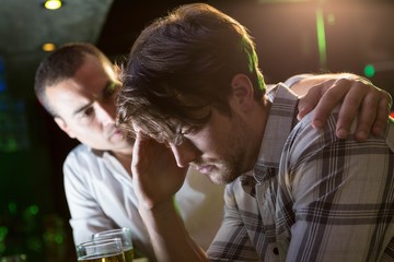 Man comforting his depressed friend