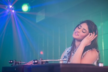 Fototapeta na wymiar Pretty female DJ playing music