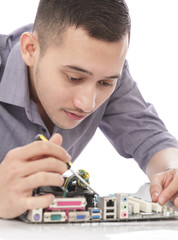 handsome young technician fixing computer hardware