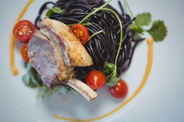 Squid ink spaghetti dish with basil 