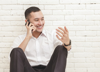 young businessman talking on the phone with hand gesture