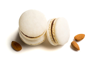 Tasty macaroons with almond on white background