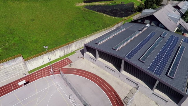 Air view on playground and school with solar panels