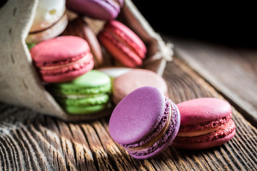 Tasty macaroons on wooden table