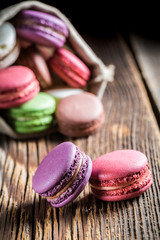 Tasty macaroons on wooden background