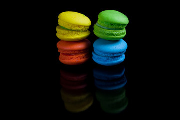 Colorful french macaroons on a black background.