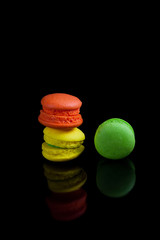 Colorful french macaroons on a black background.